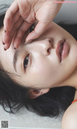 A close up of a woman's hand on her shoulder.