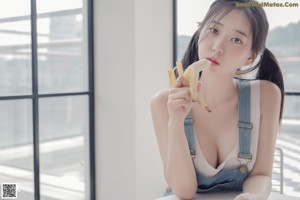 A woman sitting on a chair in a black lingerie.