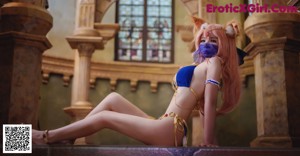 A woman with pink hair wearing a cat ears headpiece.
