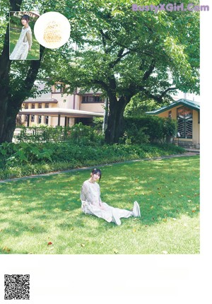 A woman laying on top of a white blanket.