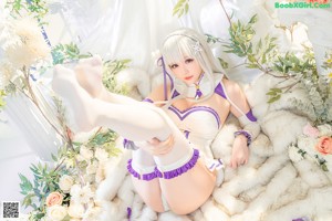 A woman in a white and purple outfit posing for a picture.