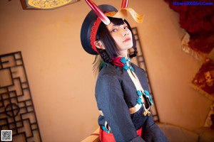 A woman dressed in a chinese costume posing for a picture.