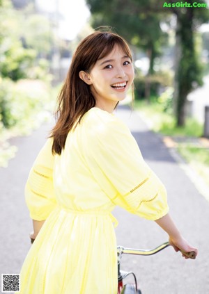 A woman in a white dress on the cover of a magazine.