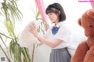 A woman in a school uniform is posing for a picture.