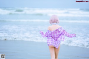 A woman in a bikini standing on a beach.