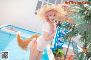 A woman in a bikini with a fox tail on her head.